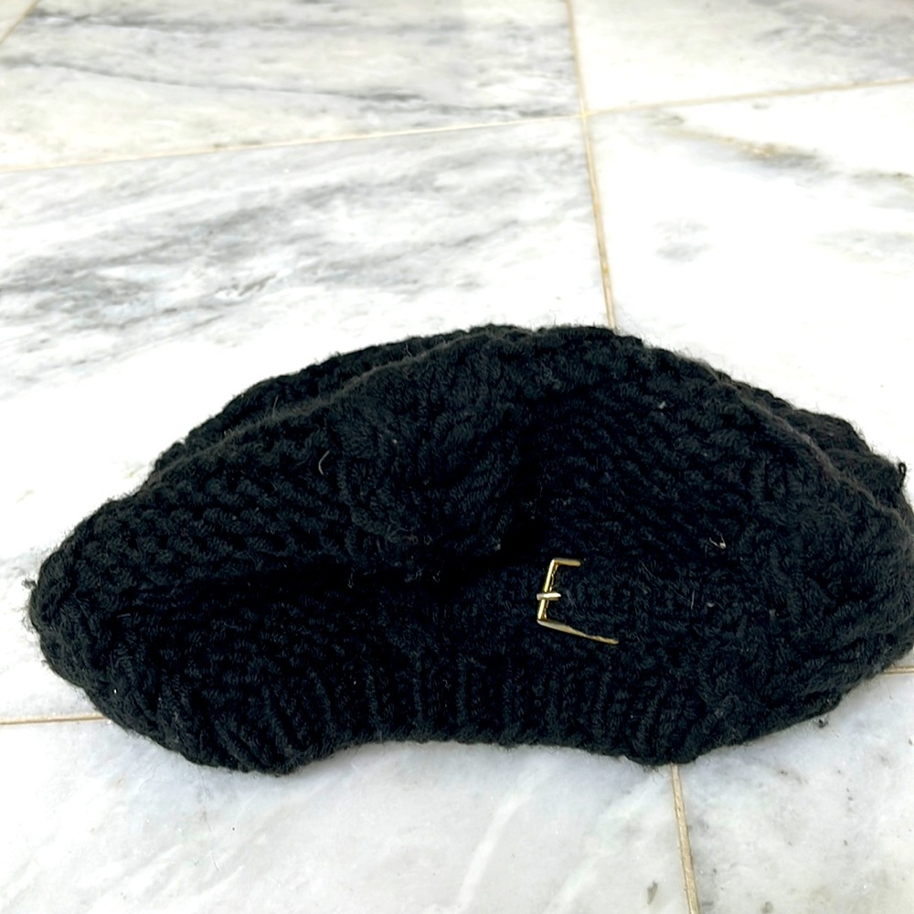 Black wool beret with gold buckle detail.